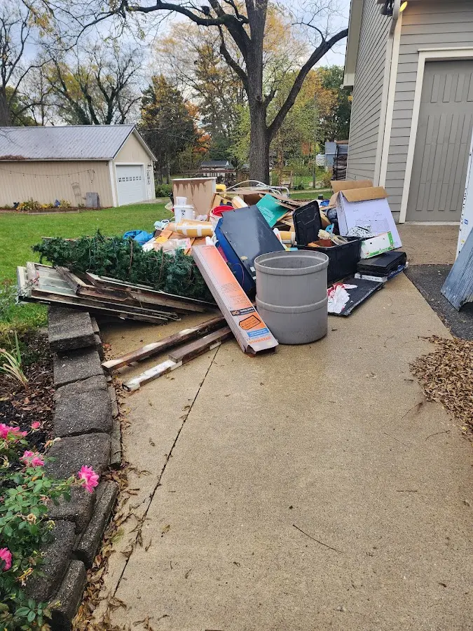 Dumpster being loaded with debris for Estate Cleanout Dumpster Rental in Margate